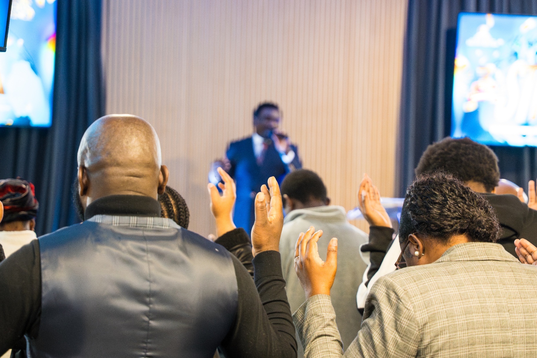 Congregation worshipping with hands raised